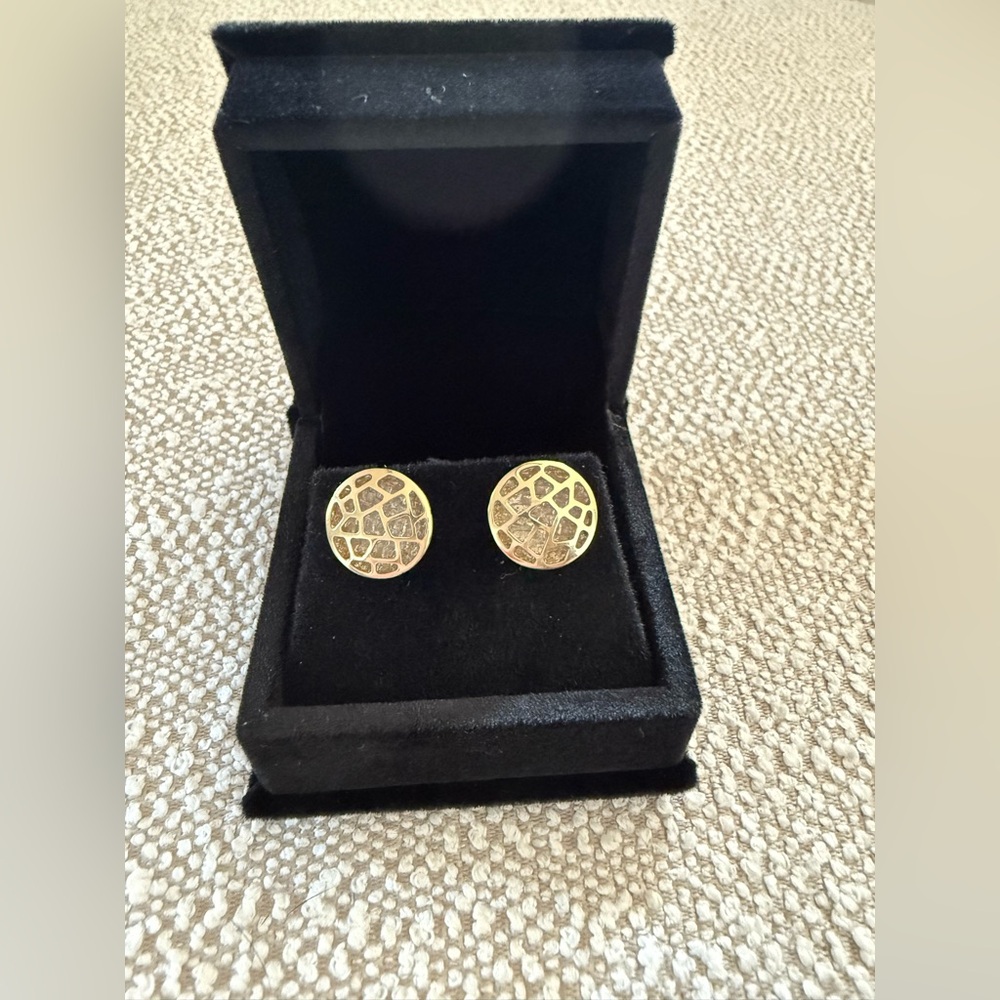 Gold studs with gemstones in the background